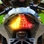 Integrated LED tail light lit on a sportbike — amber turn signals and red brake light combined in one Custom LED Blaster-X unit