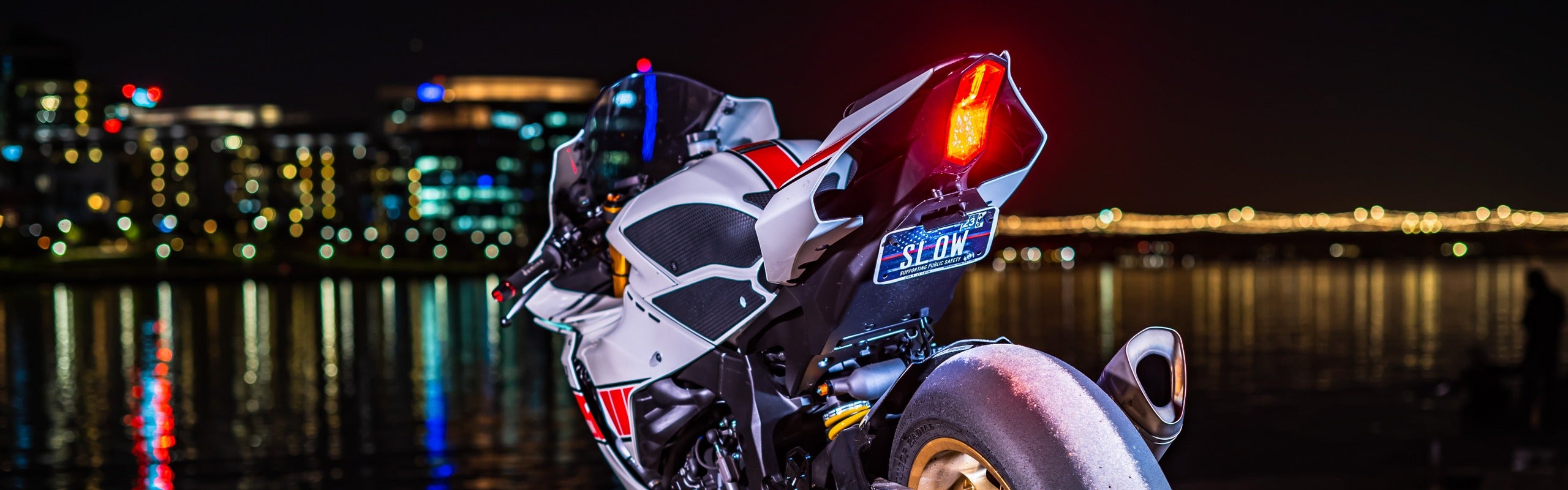 White sport bike at night with a fender eliminator, integrated LED tail light and stealth license plate bracket